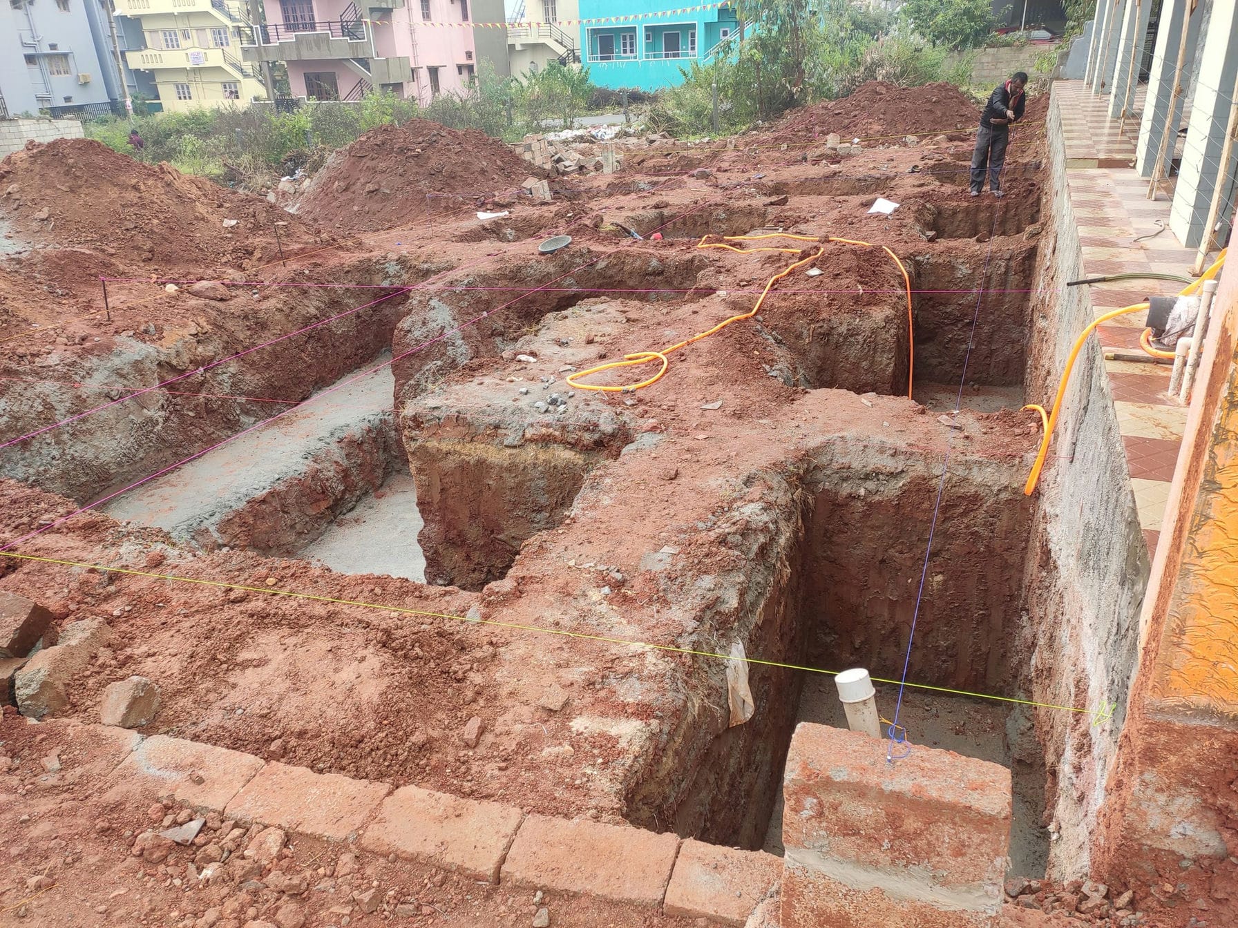 building contractor marking pillar location as per engineer plan